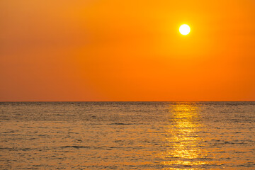 Sea view for summer vacation concept Nature of the summer beach and sea with soft sunlight. hitting the sand The sea sparkles against the sunset sky.