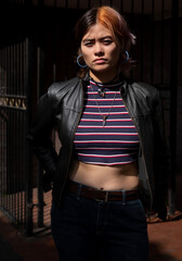 Young urban woman looking at camera with attitude.