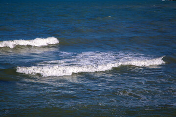 Marine dark blue background with waves with white foam
