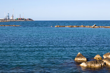 View of the sea coast with a blue sea and large rocks