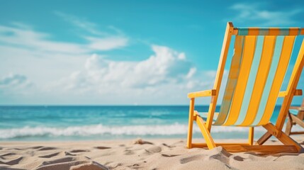 Obraz premium A beach chair is sitting on the sand next to the ocean