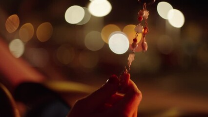 woman touching her lucky charm in a car by night with bokeh