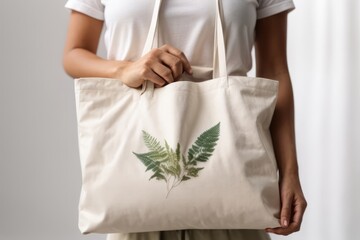person holding reusable tote bag for shopping fruit and vegetables