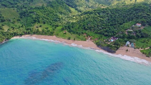 Playa Colorada is a beautiful beach in Samana, Dominican Republic. Beach with lush trees on the edge.