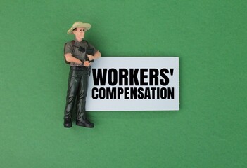 miniature people and white paper with the words workers' compensation