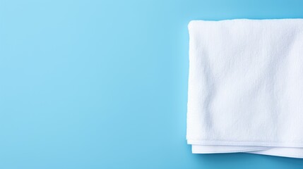 White cotton towels on a blue background. Bathroom decor and accessories.