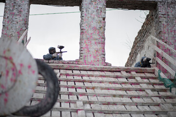 Paintball. Gun and soldier with a sports man playing a military game for fun or training outdoor. War, camouflage and target with a male athlete shooting a weapon outside during an army exercise