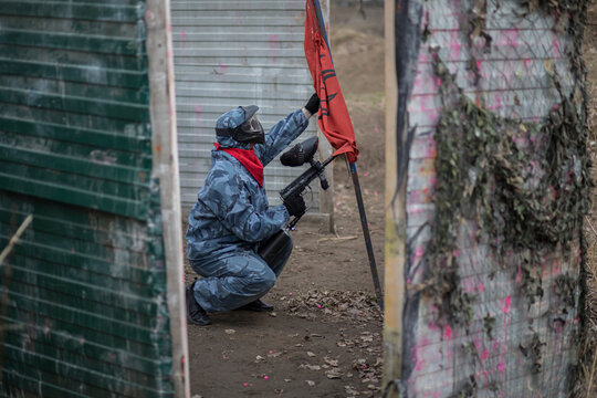 Paintball. Gun and soldier with a sports man playing a military game for fun or training outdoor. War, camouflage and target with a male athlete shooting a weapon outside during an army exercise