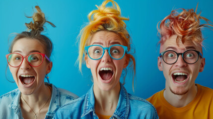 Three ecstatic friends with vibrant hair and trendy glasses expressing joy on a bright blue background.