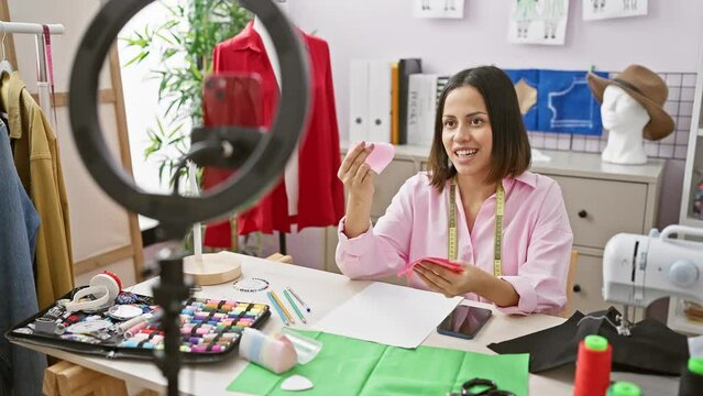 Smiling woman fashion designer working with fabric in a cozy sewing studio