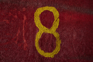 number eight 8 painted on wooden plank