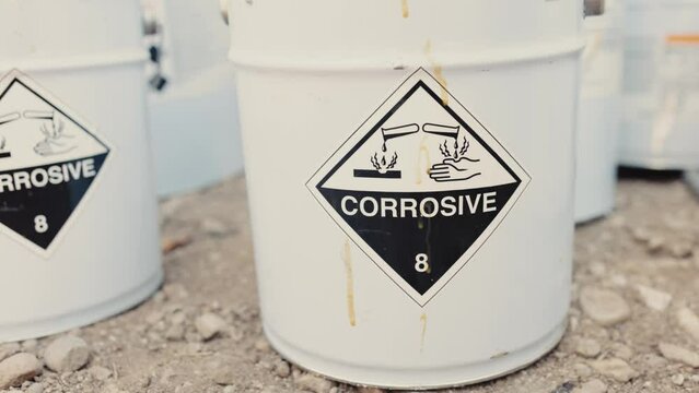 Metal containers with the toxic and corrosive symbol written on them