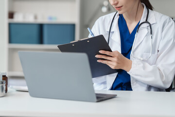 Attractive female Caucasian female doctor and psychologist gives advice, encouragement to female Asian patients. from depression in hospital examination room. cognitive behavioral therapy CBT