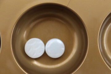 Mangala game with board and marbles set up on a table