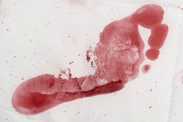 bloody footprint on a white background. bloody mark on clothes. wound