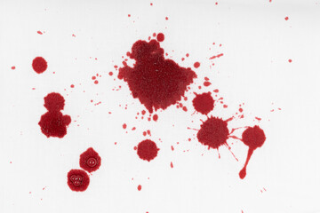 Drops of blood stains on white fabric. blood splatters on clothes. red dripping blood spatters