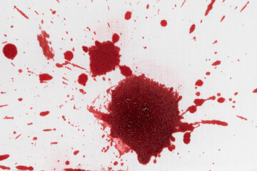 Drops of blood stains on white fabric. blood splatters on clothes. red dripping blood spatters