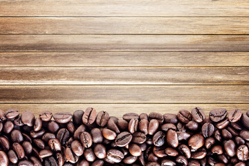 Top view with roasted coffee beans on wood table background area for copy space