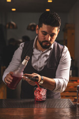 Expert bartender pouring cocktail at bar - 763003296