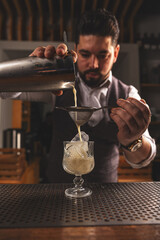 Expert bartender crafting a cocktail - 763003412