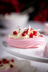 Pink meringue decorated with cream