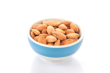 Bowl of almonds isolated on white background