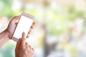 Women hand shows mobile smartphone in vertical position with blurred green bokeh background