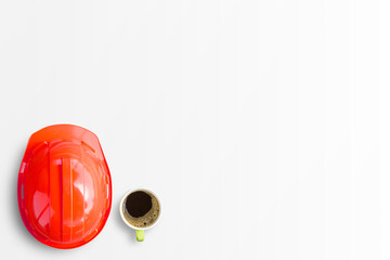 Red safety engineer helmet and cup of coffee isolated on white background.