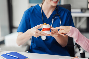 Caucasian female doctor explain to asian female patient using Human Anatomical Lumbar Disc...