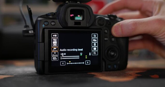 Photographer's Hand Pressing Button And Adjusting The Settings Of A Camera. - close up shot