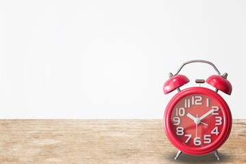 Red alarm clock on wood table background