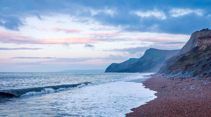 Dawn at Eype beach on the Dorset Jurassic coast south west England UK - obrazy, fototapety, plakaty