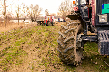 Low view of tractor as travel on wet ground