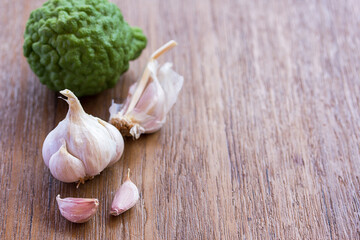 Top view of garlic on wood table background with copy space for design.