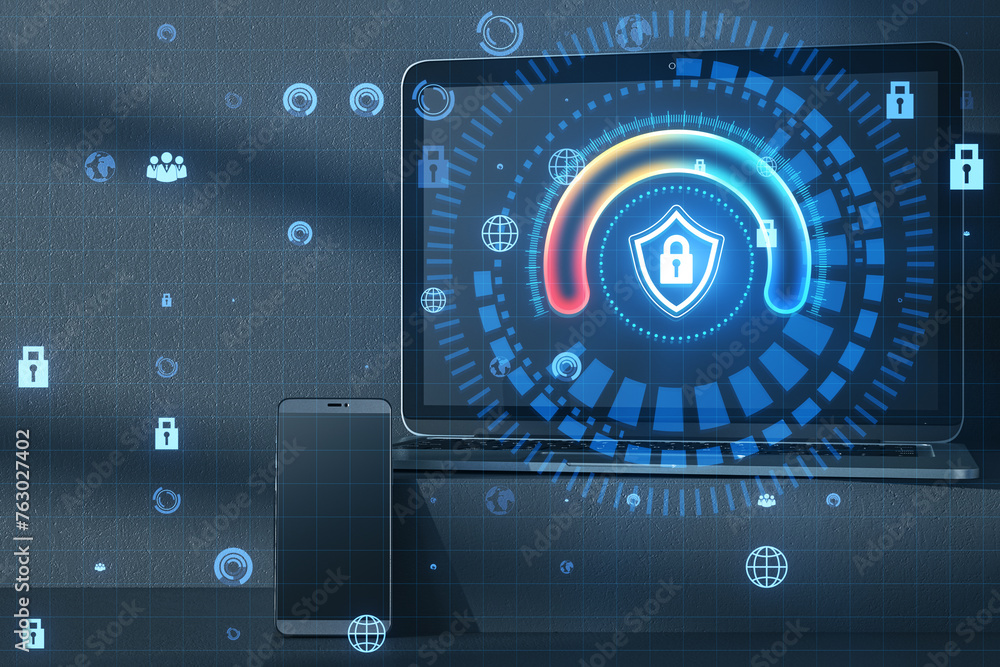 Poster close up of laptop and smartphone with glowing round padlock shield hologram on concrete wall backgr