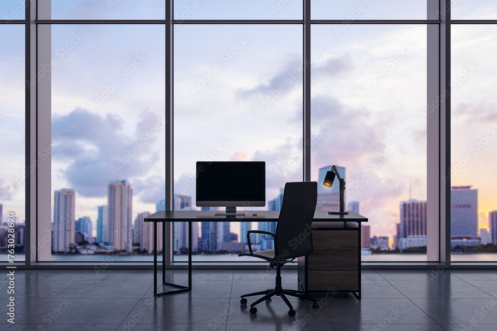 Poster Luxury office interior with empty computer monitor on desk and panoramic windows with beautiful city view and daylight. Mock up. Workplace concept. 3D Rendering.