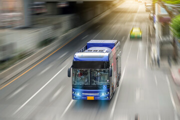 City bus rides along a metropolis street with its headlights on with motion rapid blur speed effect, aerial view