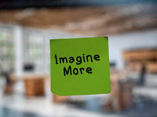 Post note on glass with 'Imagine More'.