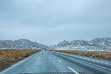 Hainan Mongolian and Tibetan Autonomous Prefecture, Qinghai Province-Grasslands and roads under the snow-capped mountains