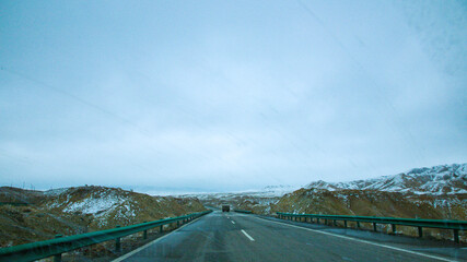 Hainan Mongolian and Tibetan Autonomous Prefecture, Qinghai Province-Grasslands and roads under the snow-capped mountains