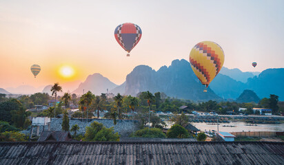 Colorful hot air balloons flying over mountain at Vang Vieng, Laos.