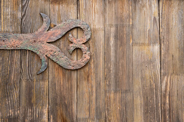 Antique wooden gate with wrought iron decorations.
