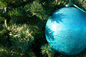 Dressed up Christmas tree. Christmas colored toys on green branches. Festive background for writing...