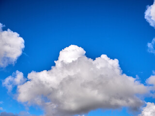 White fluffy clouds in the deep blue sky. Heaven background