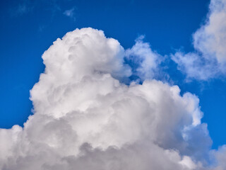 White fluffy clouds in the deep blue sky. Heaven background