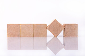 Five wooden block of cubes with empty space for copy word, message, lie on a white reflective...