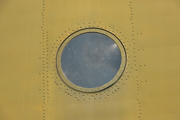 closeup of a military spec helicopter fuselage and viewing window