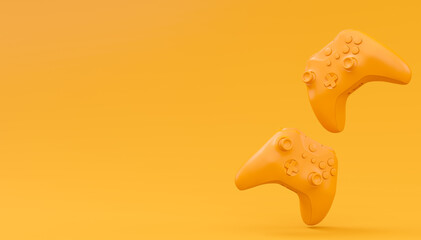Video game joysticks or gamepads in plain monochrome yellow color background © Vasyl Onyskiv