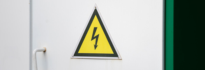 High Voltage Alert: Electricity Warning Sign on the Door