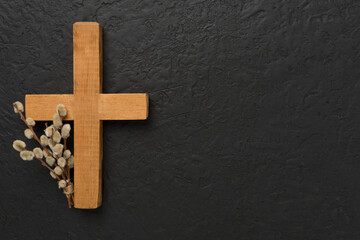 Cross with willow branches on concrete background, top, view. Palm Sunday concept